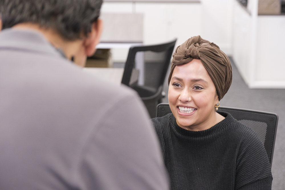 Businesswoman talking to Croft employee.