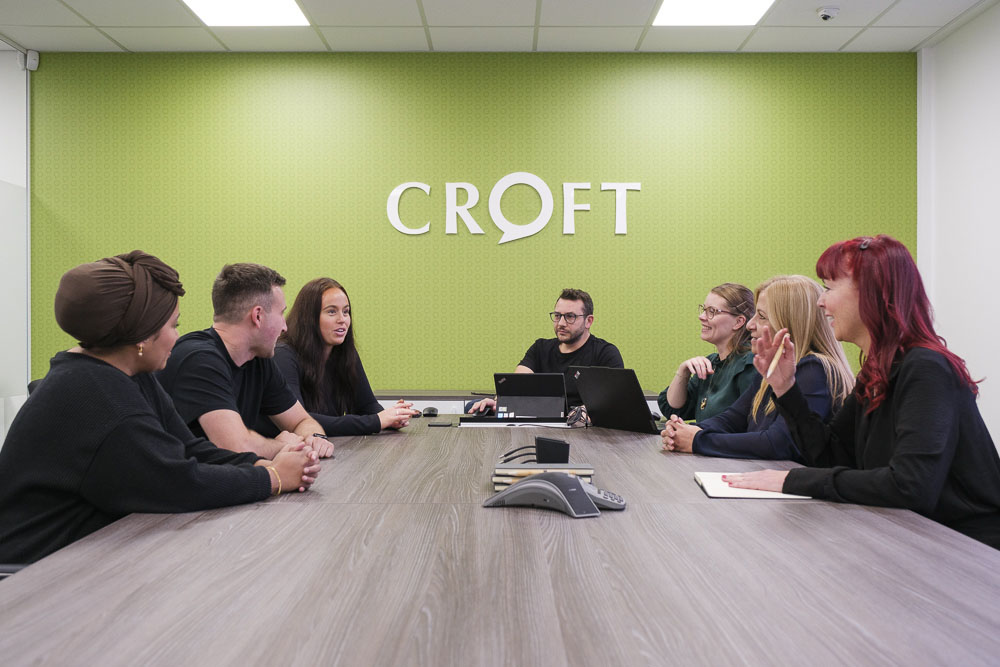 Contact Croft experts meeting in a meeting room.