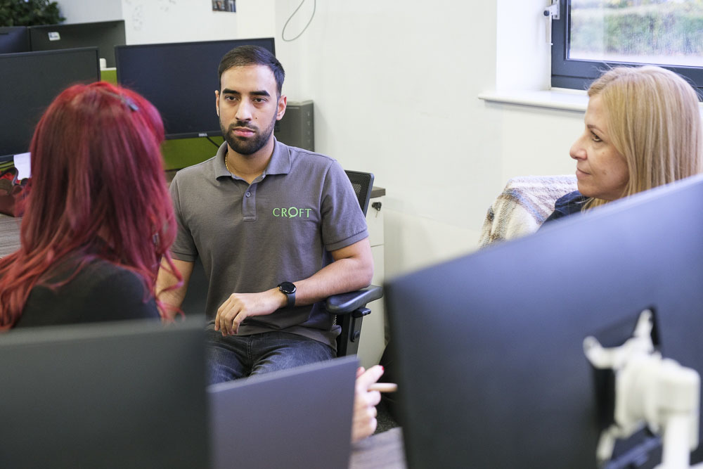 Croft meet the team employees sitting down and informally chatting in our Hartford office