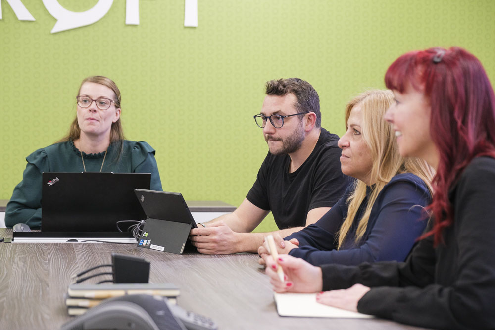 Croft meet the team employees meeting in our Hertford office meeting room with their laptops.