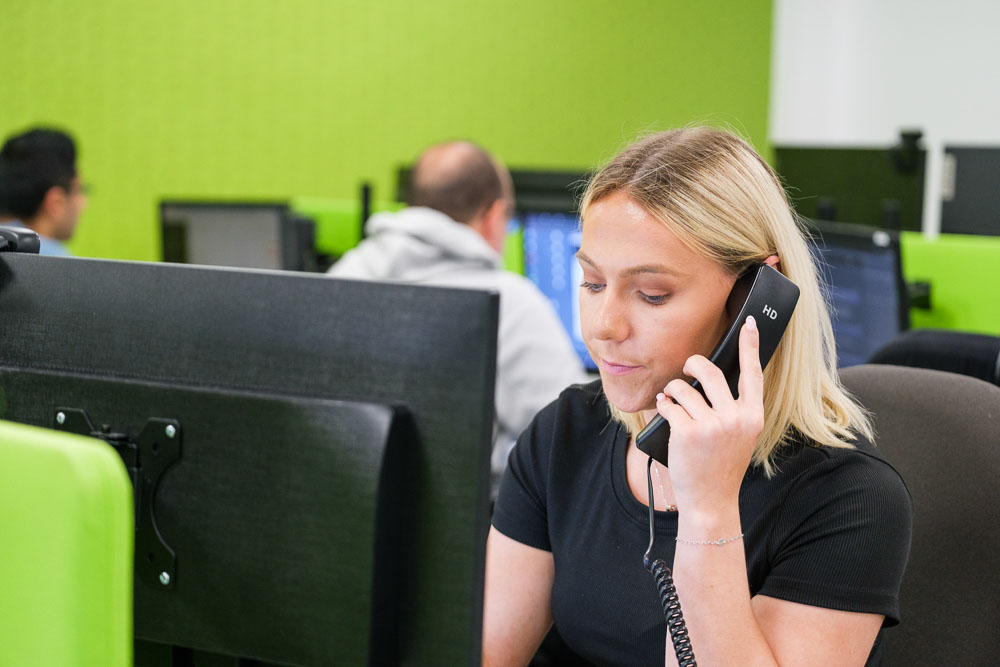 Croft meet the team employee talking on a desktop phone in our Midlands office.